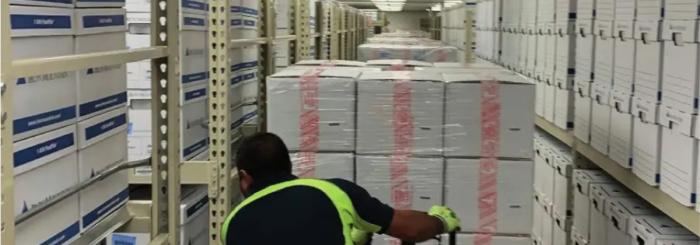 Photograph of boxed archival materials being moved