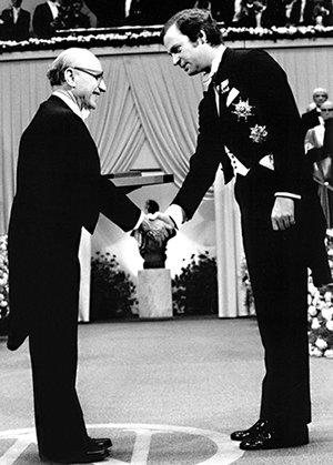 Milton Friedman receives the 1976 Bank of Sweden Prize in Economic Sciences in Memory of Alfred Nobel from King Carl XVI Gustaf of Sweden.