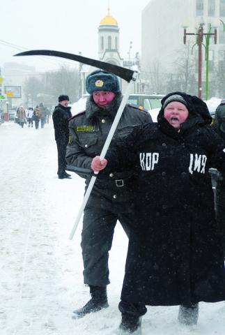 Moscow police officer detains a demonstrator