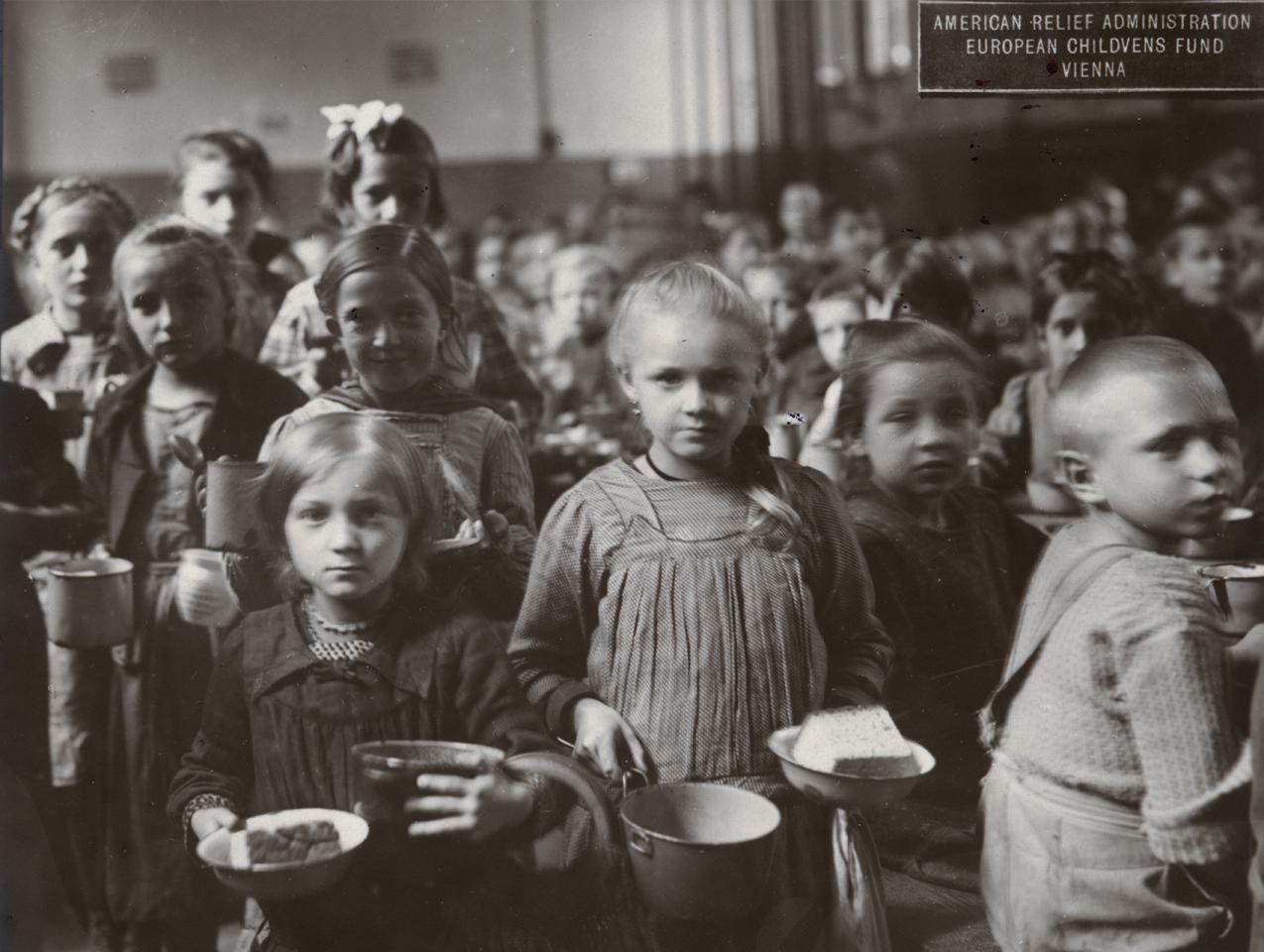 Black and white photograph of children receiving food at an American Relief Administration kitchen in Vienna