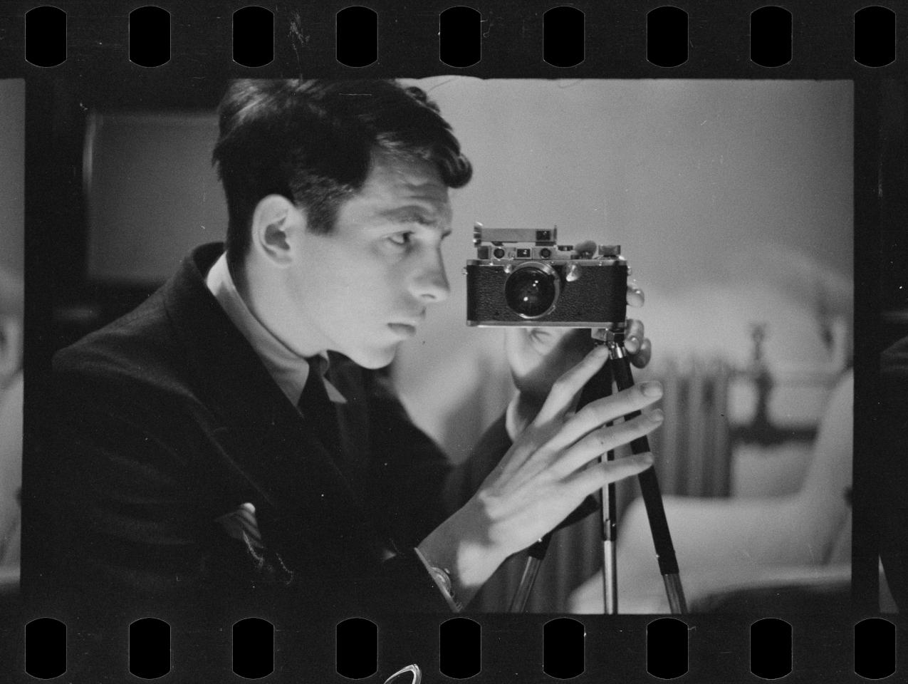 Buchman taking a self-portrait with his camera. Digitized black and white photo negative.