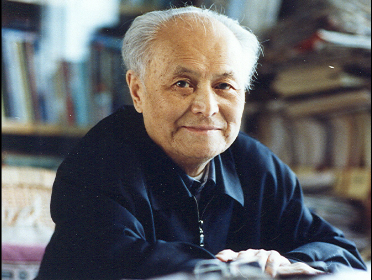 Color photograph of Li Rui at desk