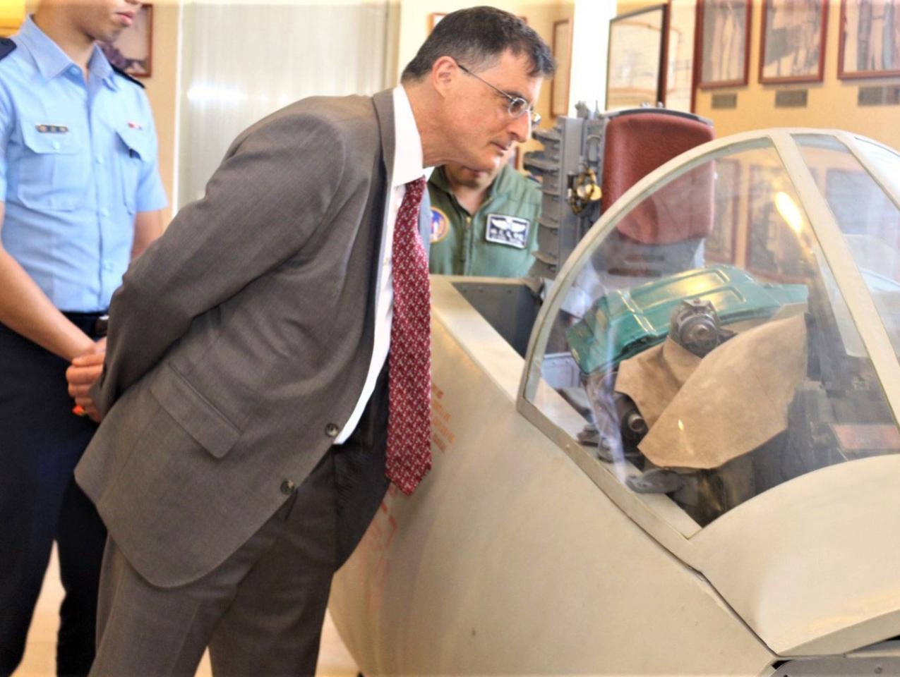 Eric Wakin looking into the cockpit of a plane on display in the American Footprint Museum