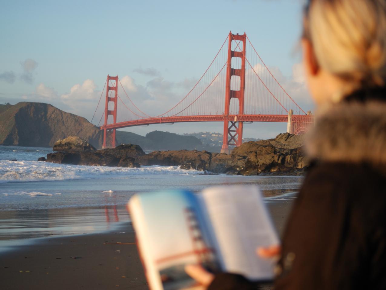Californian reading a book near the Golden Gate Bridge