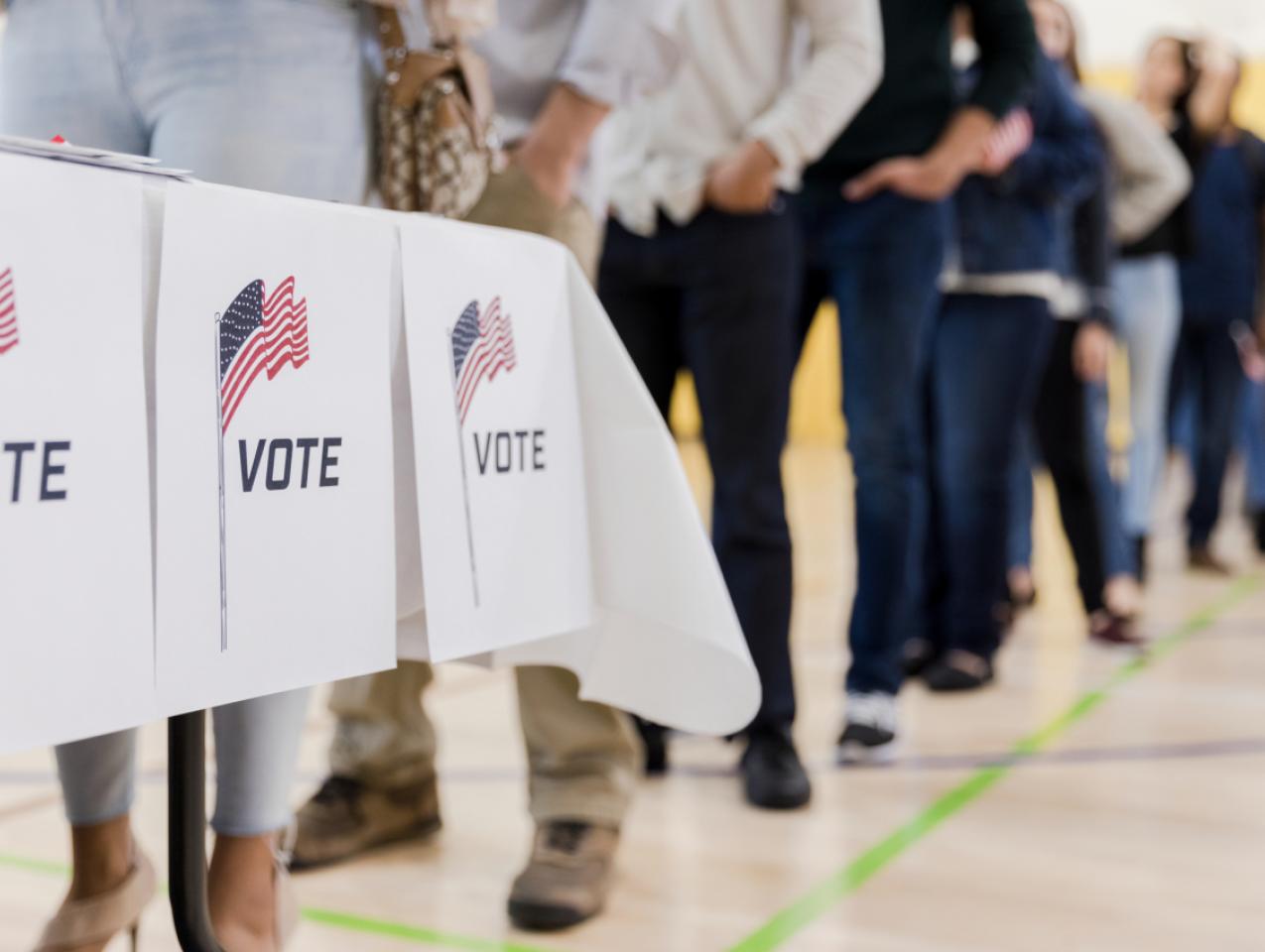 Low angle view of people lined up to vote stock photo