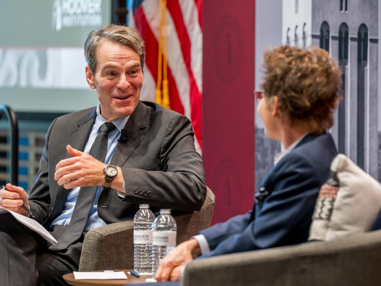 Senior Fellow John H. Cochrane speaks with SF Fed President and CEO Mary C. Daly in Shultz Auditorium on December 6, 2024. (Steve Castillo)