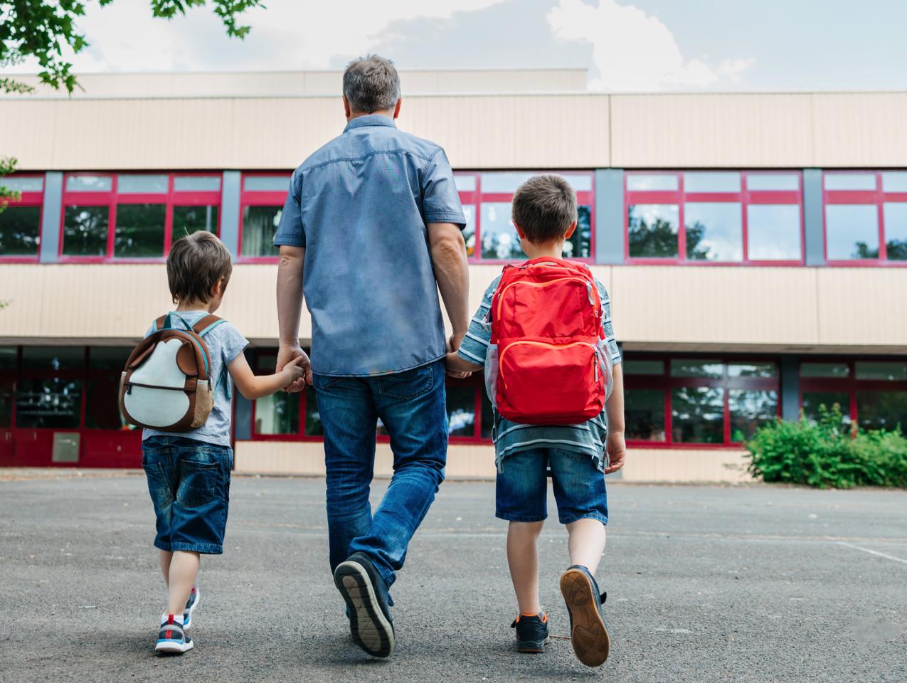 dad escorts his sons to school 