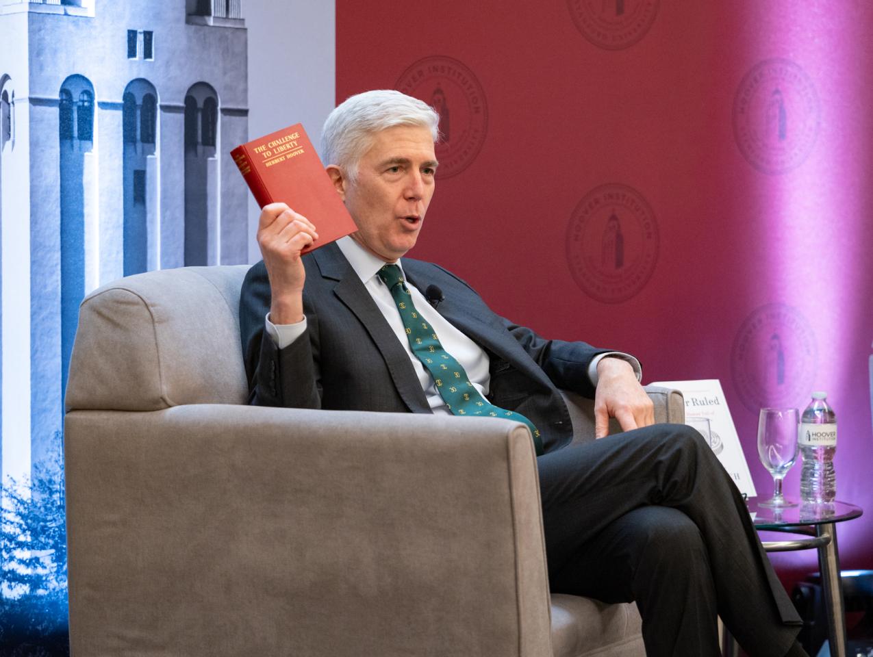 US Supreme Court Justice Neil Gorsuch holds up a copy of Herbert Hoover’s The Challenge to Liberty while speaking at the Hoover Institution’s Winter Board of Overseers meeting on February 24, 2025. 