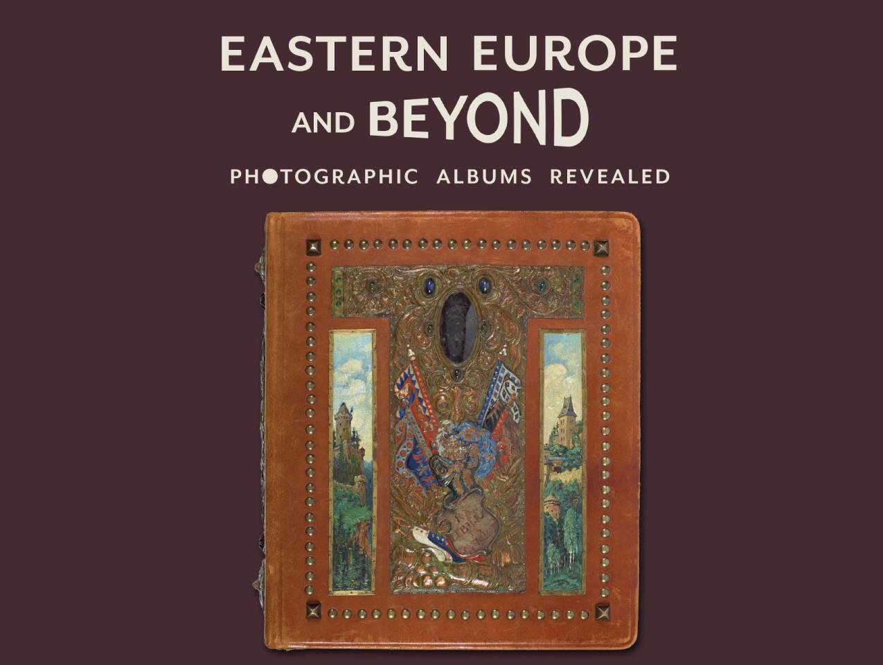 Purple background with title in cream above a leather bound photo album covered in paintings, metalwork, and jewels. Gajda Album
