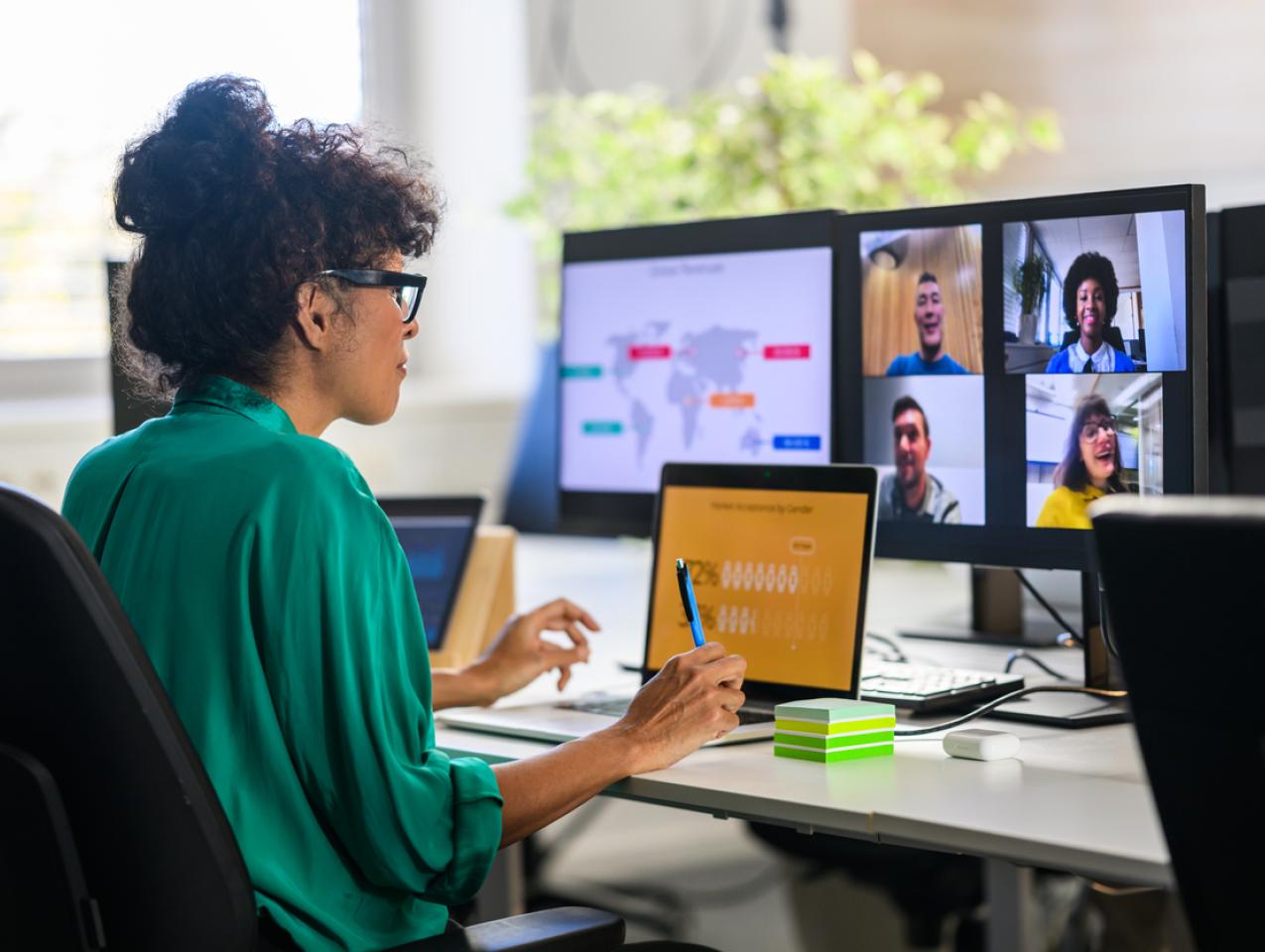 Woman discussing report with remote workers stock photo