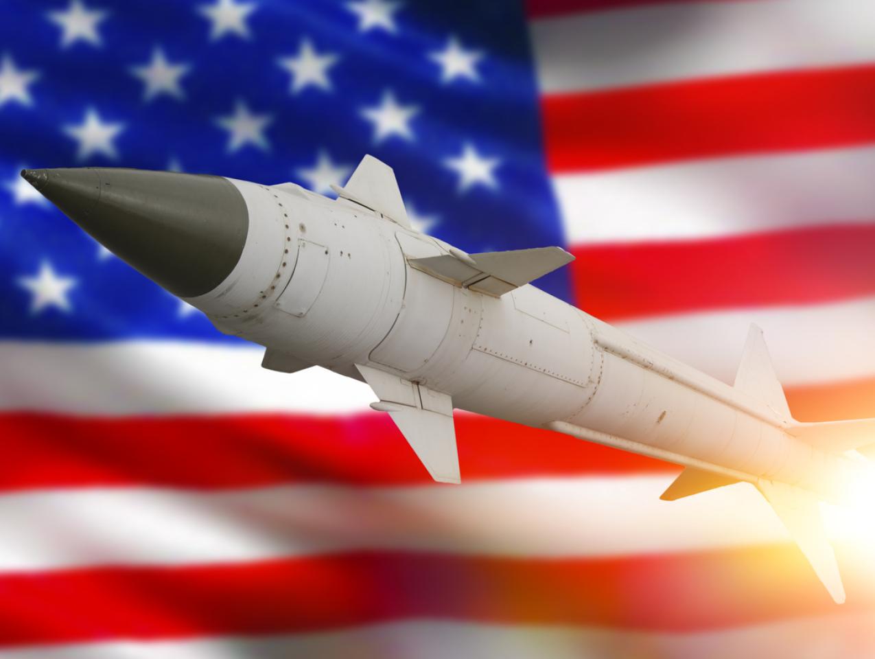Rocket with a warhead against the background of the flag of the United States of America stock photo