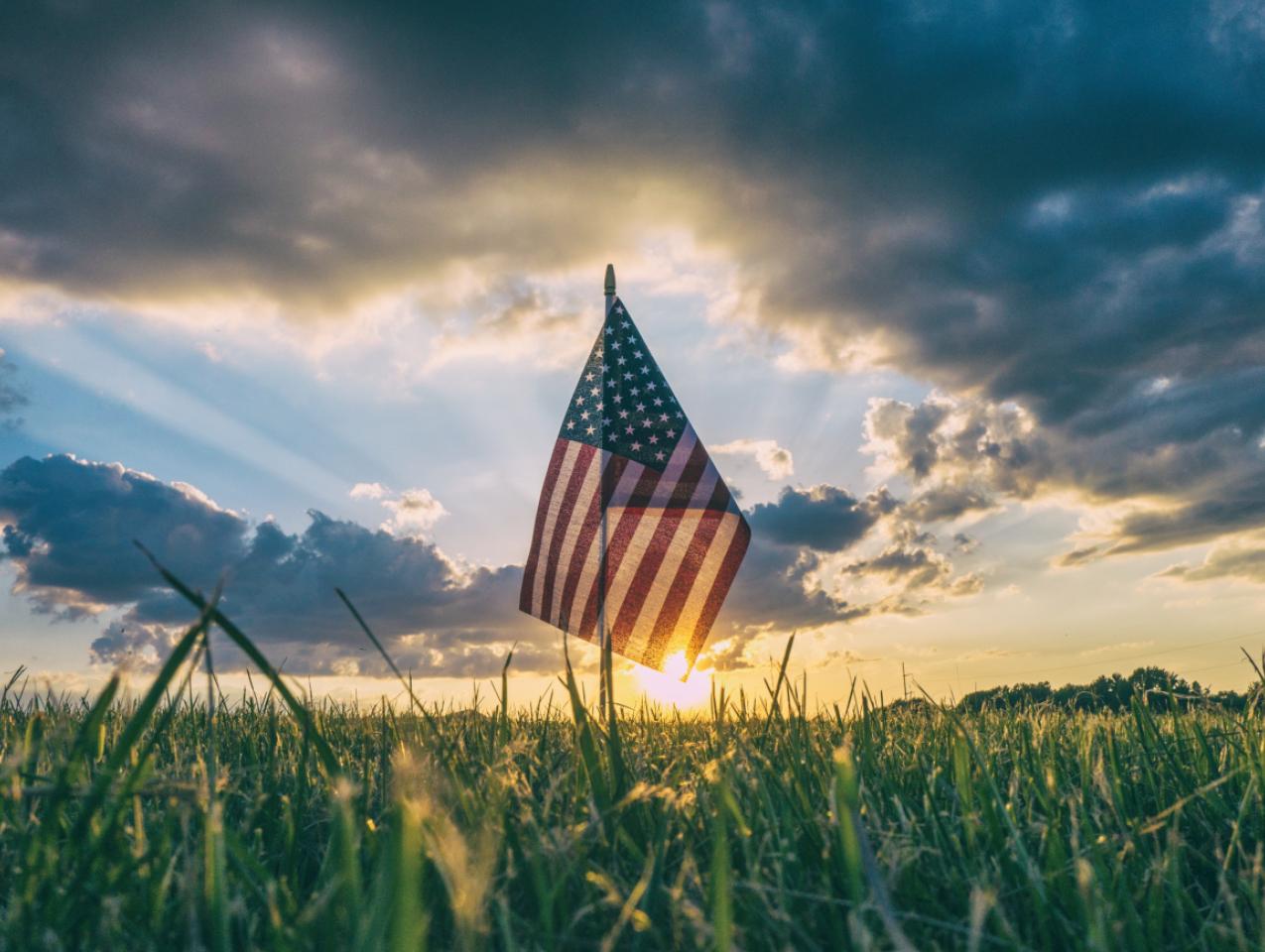 American Flag flying over a field