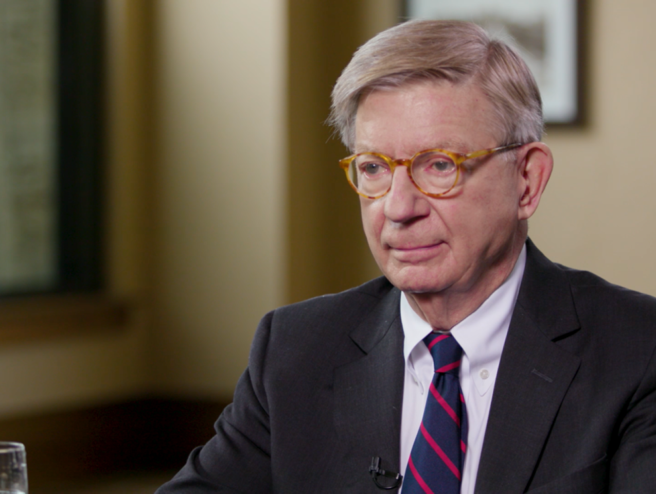 Image of George F. Will sitting at a table.