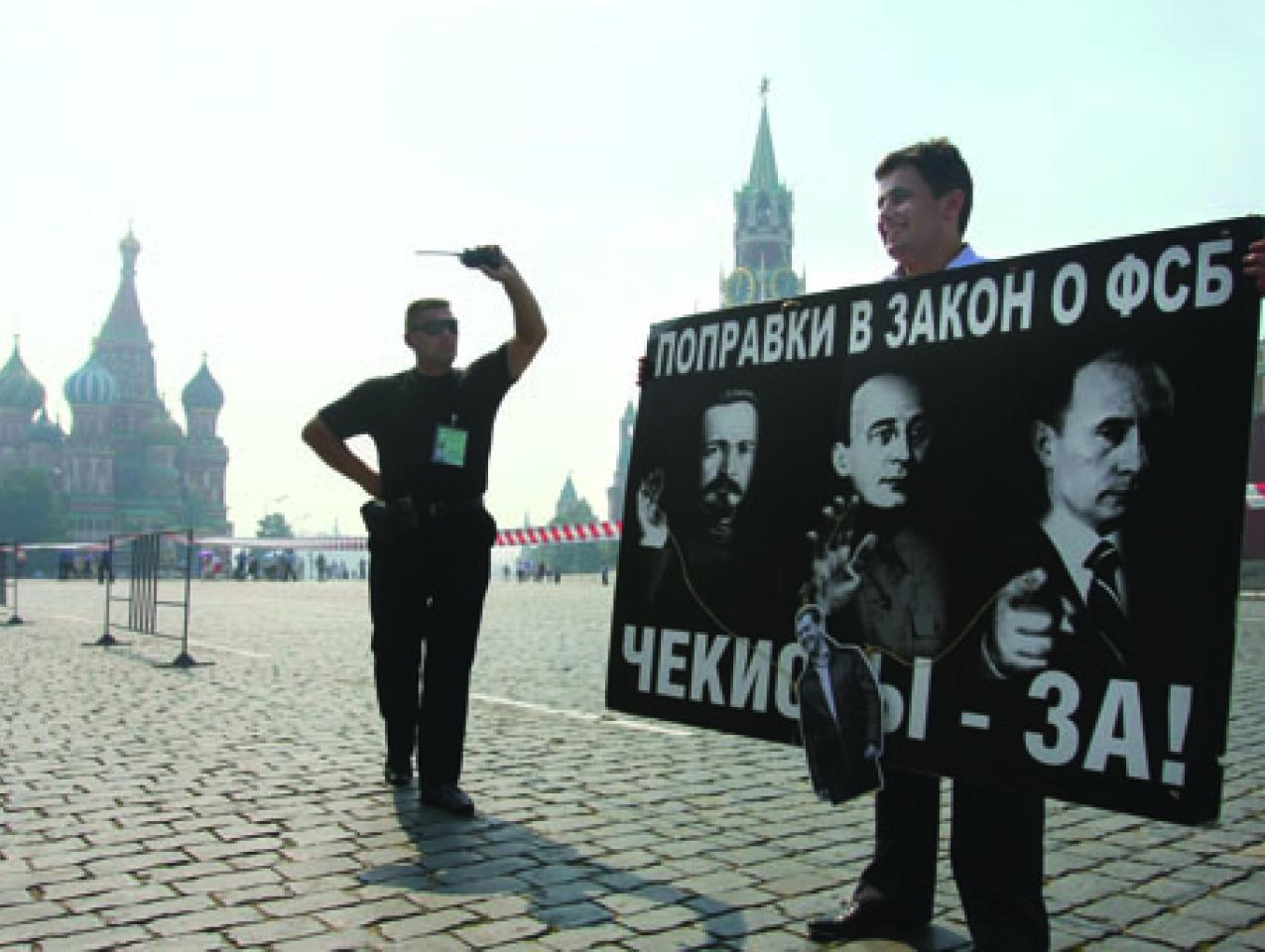 A security officer confronts a Red Square protester