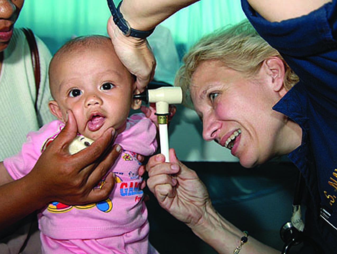 Ronda Bouwens examines a baby