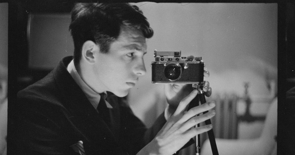 Buchman taking a self-portrait with his camera. Digitized black and white photo negative.