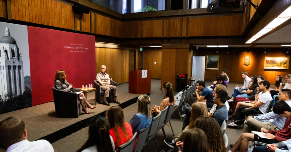 Amy Zegart (left) and General Paul Nakasone in a fireside chat at the Hoover Institution with an audience of Stanford University students.