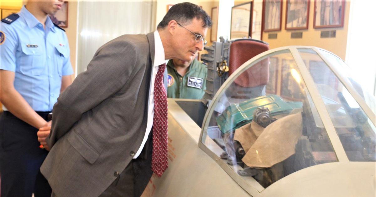 Eric Wakin looking into the cockpit of a plane on display in the American Footprint Museum