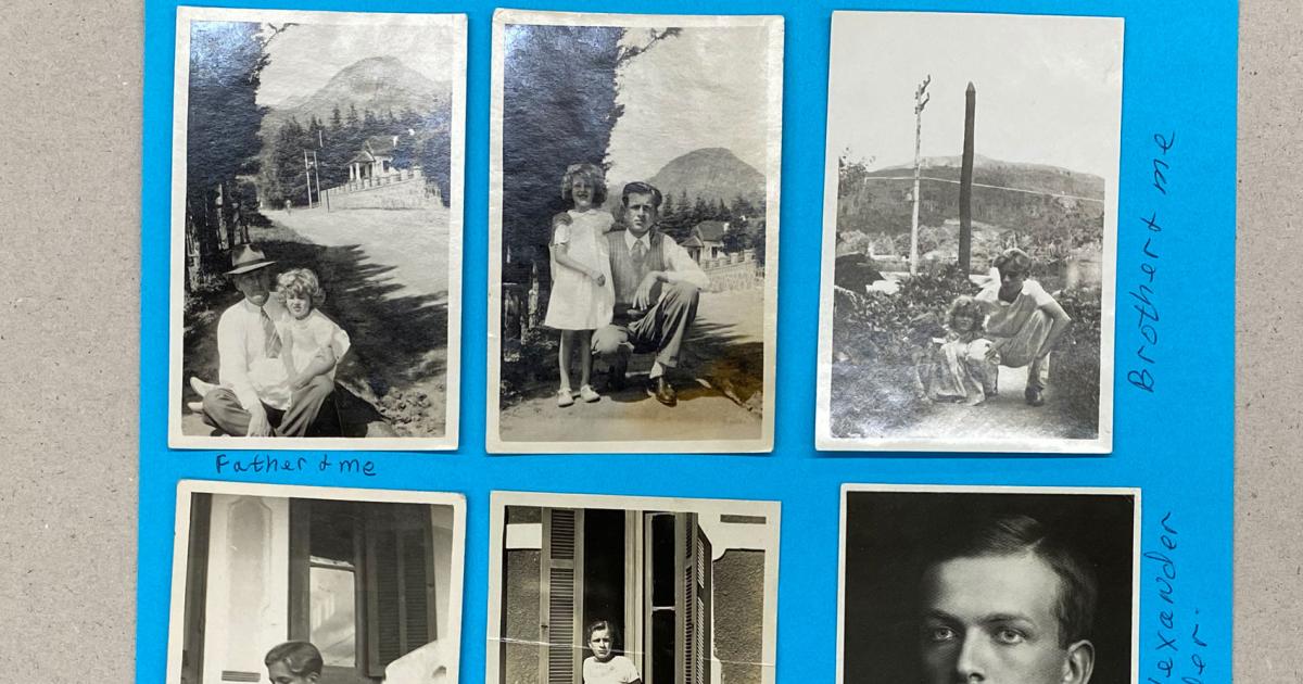 Six black and white photographs adhered to blue paper.