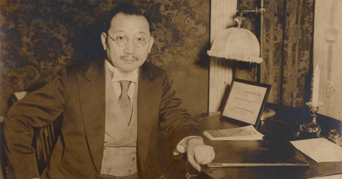 Sepia tone photograph of H. H. Kung seated at desk, 1930s