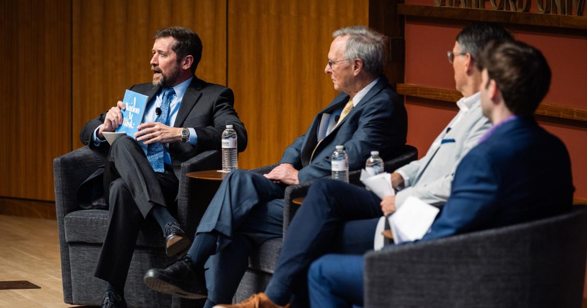 Hoover Education Success Initiative Director Stephen Bowen (left) holds a copy of the original 1983 A Nation at Risk report on US public education during a panel discussing the history of public education reform on January 10, 2025. (Patrick Beaudouin)