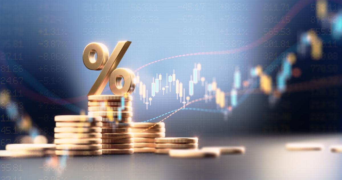 Percentage Sign On Top Of Coin Stacks Before Blue Financial Graph stock photo
