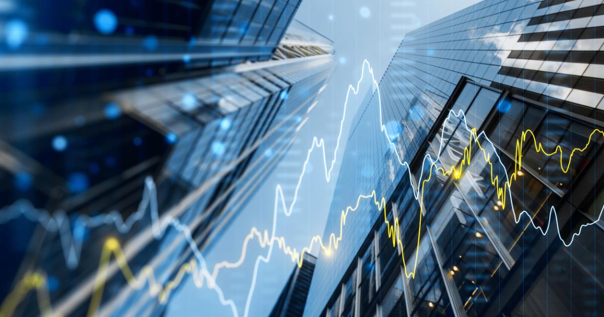 A double exposure image of skyscrapers with overlay of financial graphs, set against a blurred background, illustrating the concept of business growth stock photo