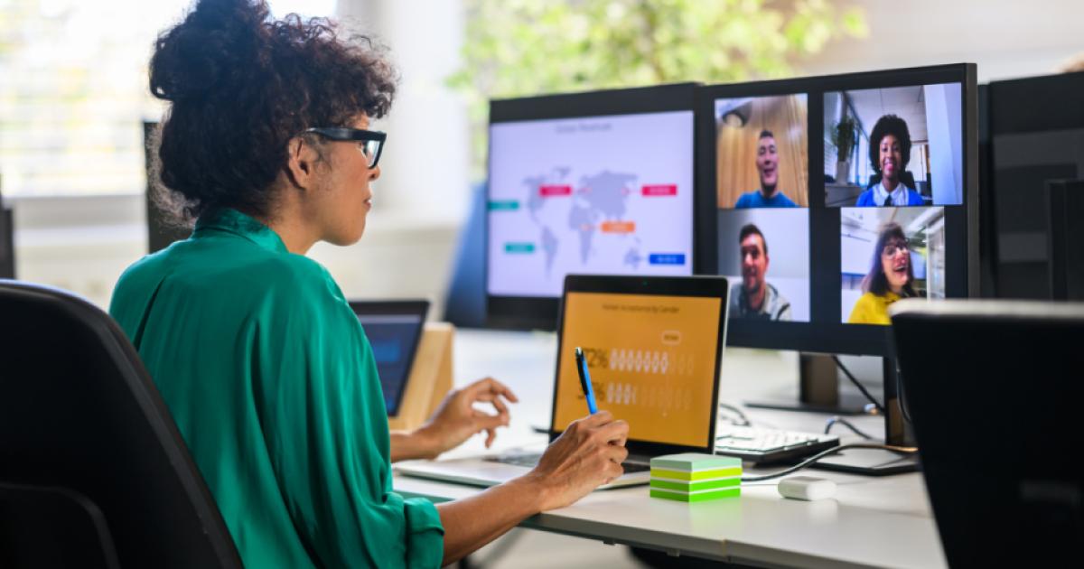 Woman discussing report with remote workers stock photo