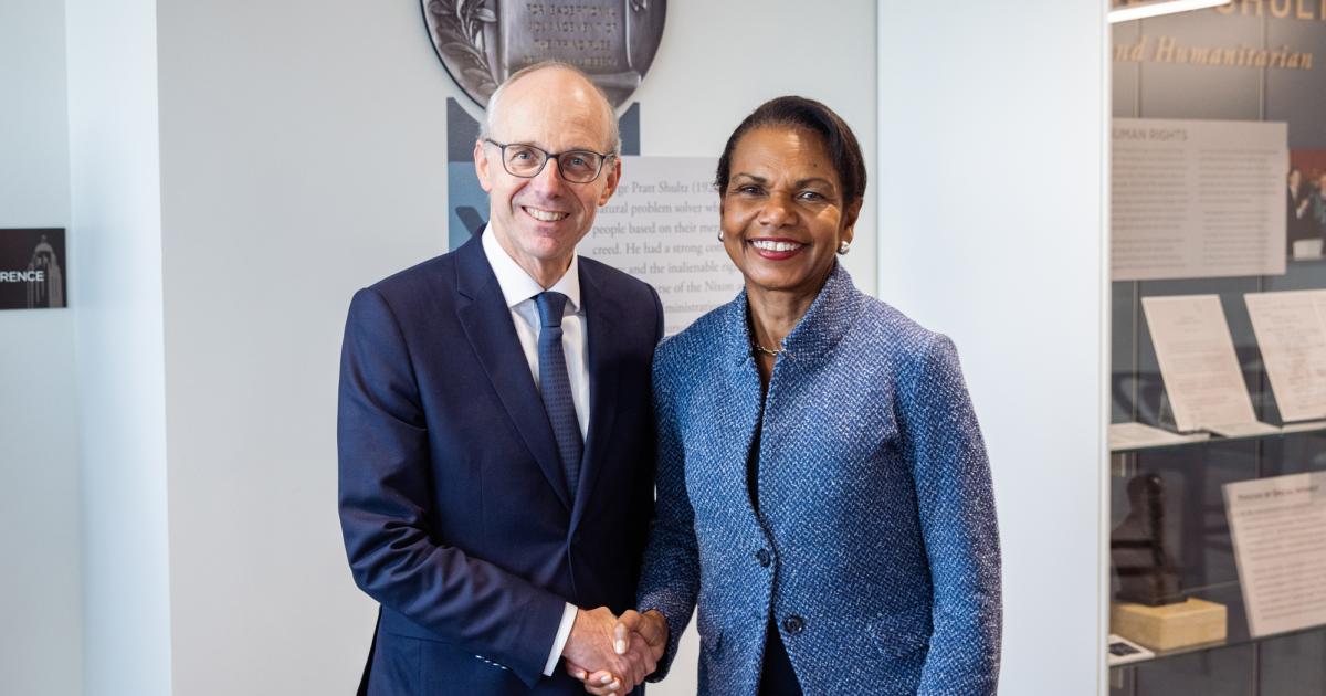 Luxembourg Prime Minister Luc Frieden and Hoover Institution Director Condoleezza Rice shake hands in Hoover’s George P. Shultz Building on November 11, 2025. (Patrick Beaudouin) 