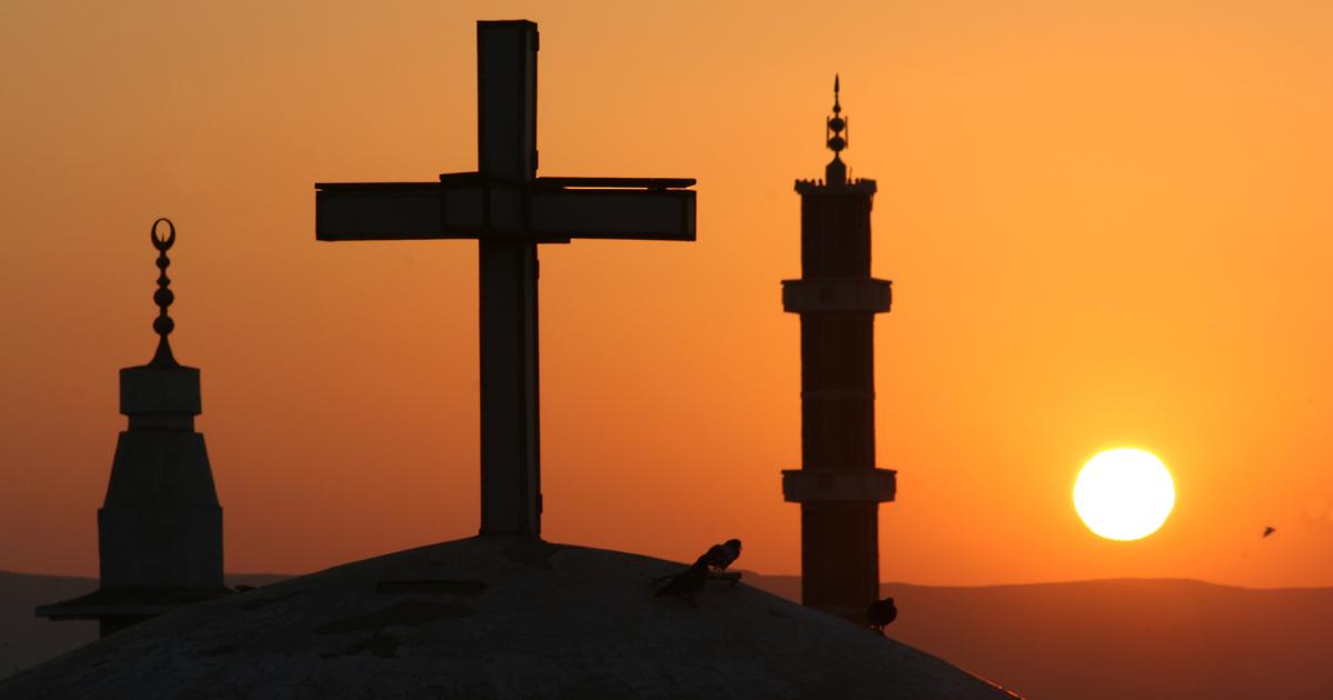 Egyptian sunrise with cross and crescents stock photo