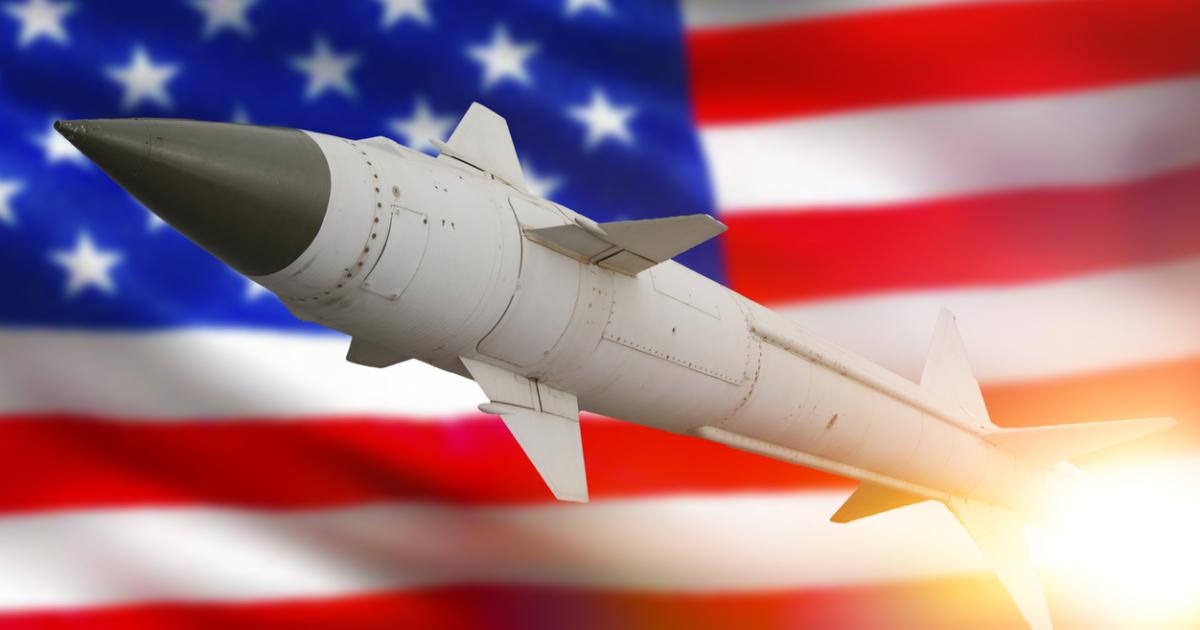 Rocket with a warhead against the background of the flag of the United States of America stock photo