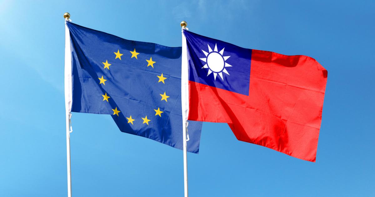 European Union flag and Taiwan flag on cloudy sky. waving in the sky stock photo