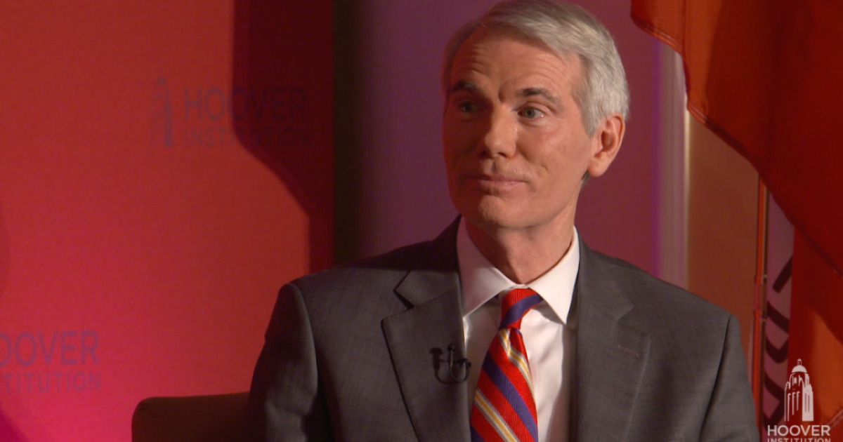 Image of Senator Rob Portman in front an orange-red background