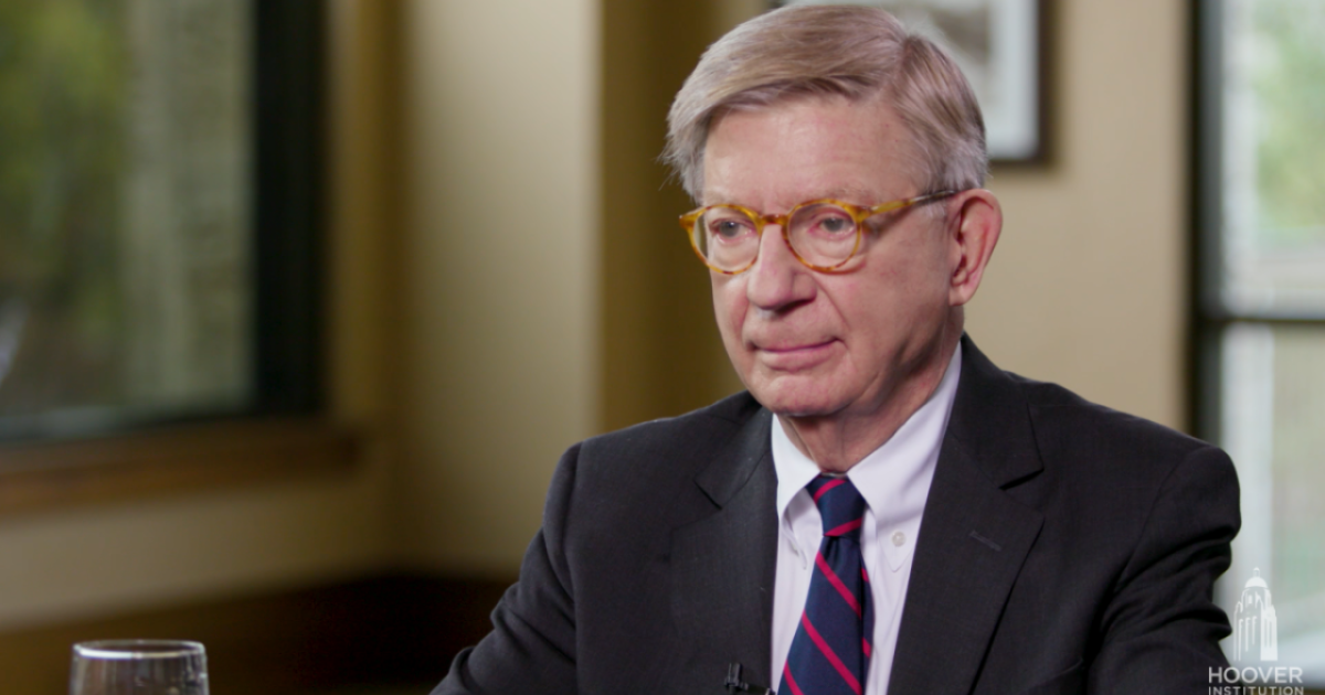 Image of George F. Will sitting at a table.