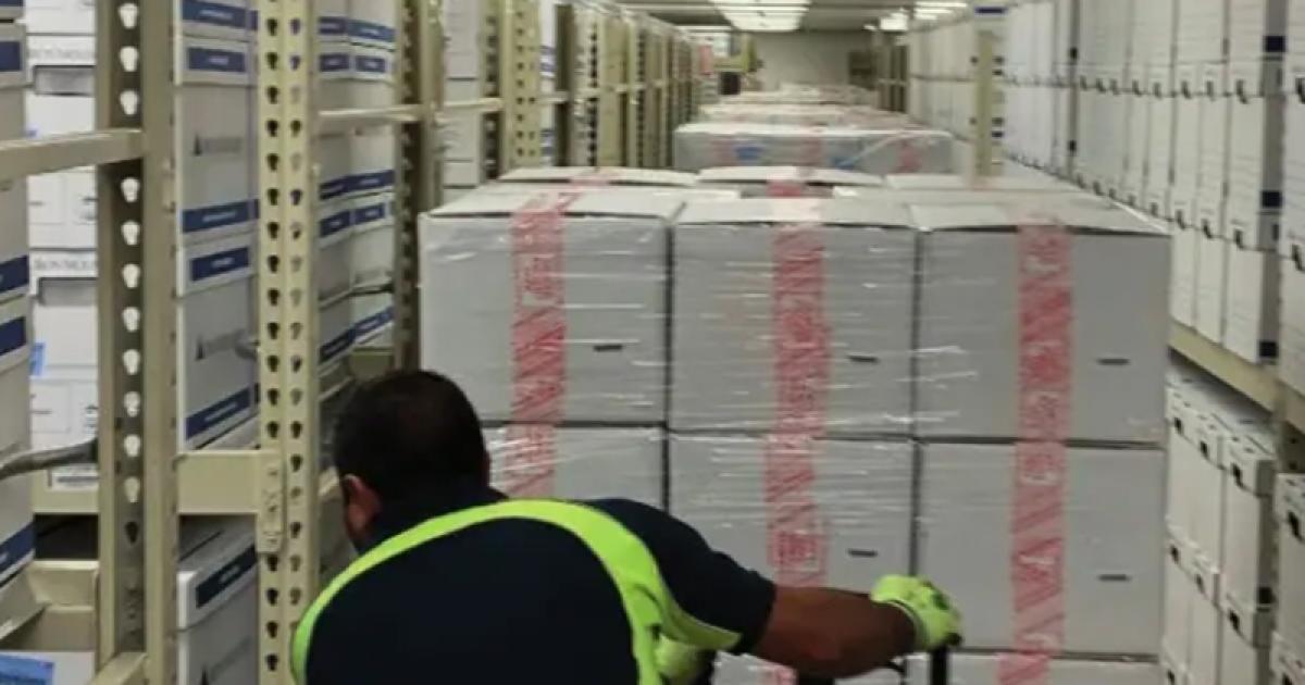 Photograph of boxed archival materials being moved