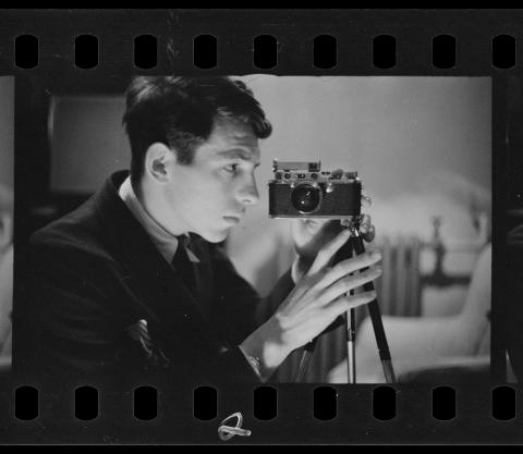 Buchman taking a self-portrait with his camera. Digitized black and white photo negative.