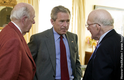 President Bush (center) listens to Hoover senior fellow Sidney Drell. At left is George P. Shultz, the Thomas W. and Susan B. Ford Distinguished Fellow.