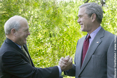 Hoover senior fellow John Cogan and President George W. Bush greet each other on Friday afternoon.