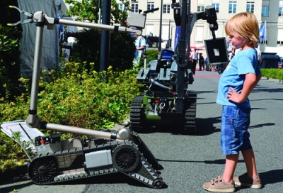 Boy meets robot at a Defense Ministry in Berlin