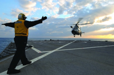 A French rescue helicopter lands aboard the U.S. amphibious command ship