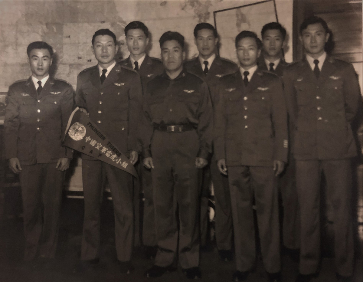 Zhou Shilin (second from left) standing with a group of 8 men in military uniform (Thunder Tigers)